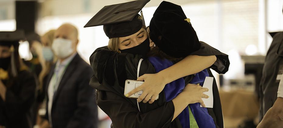 A student hugs a professor
